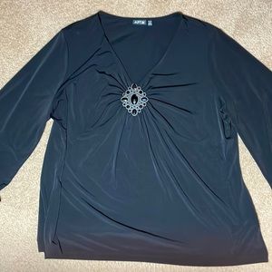 Beautiful black top with a great center piece. Size 1 X.